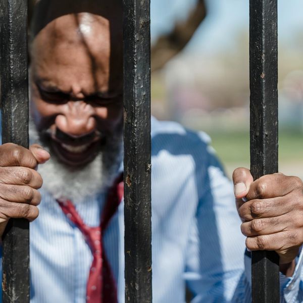 Close-up of a man's hands gripping a pull-up bar.